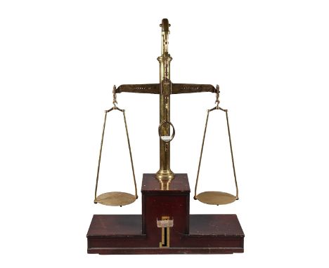 A set of 56lb industrial brass beam scales by De Grave and Co Ltd of London, c. 1900, on a stepped wooden base with foot oper