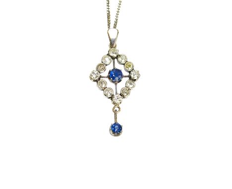 A sapphire and diamond pendant, in an openwork lozenge shaped cluster design, claw set with the circular cut sapphire at the 