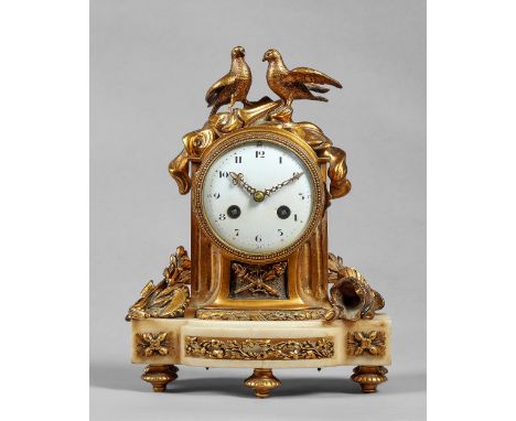 A French ormolu and white marble mantel clockIn the Louis XVI style, circa 1900The fluted arched case surmounted by a pair of