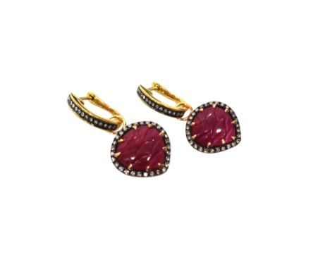 A pair of 18ct gold, ruby and diamond earrings, each heart shaped drop centred by a carved ruby, within a surround of circula