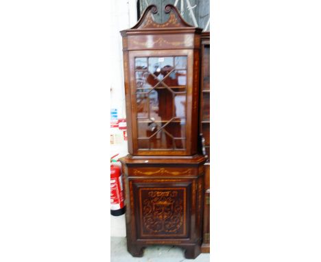 A near pair of late 19th century marquetry inlaid mahogany corner cabinets, each with swan neck cornice over astragal door an