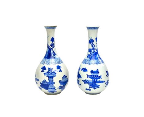 A near pair of Chinese blue and white vases, Kangxi, of elongated pear form, each painted with Precious Objects beneath a ruy