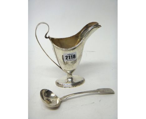 A Scottish silver milk jug of helmet shaped form, with floral and foliate engraved decoration, raised on a loaded foot, Edinb