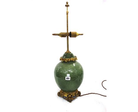 A Chinese celadon and ormolu table lamp, modern, with silk shade, 68cm high overall.