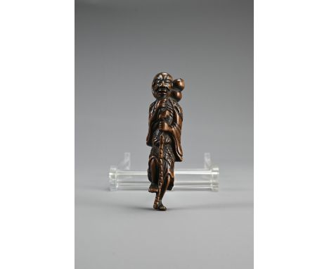 JAPANESE EDO BOXWOOD NETSUKE OF CHOKARO SENNIN, 18th century, standing on one foot, with one hand stroking his beard and the 