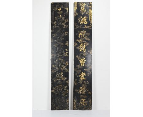 A TALL PAIR OF CHINESE BLACK LACQUERED AND GILT WOOD PANELS, 19/20TH CENTURY. Gifted under the rule of Ruan Zhidong, the head