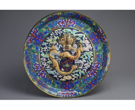 A VERY LARGE CHINESE BRONZE CLOISONNE ENAMEL DRAGON CHARGER, 19/20TH CENTURY. Deep circular dish with raised dragon and flami