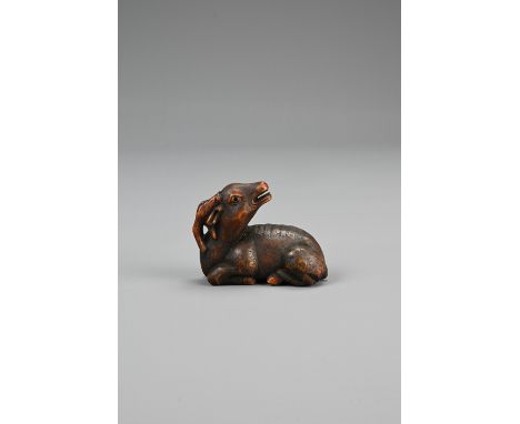JAPANESE SHOWA PERIOD BOXWOOD NETSUKE OF A RECUMBENT STAG, 20th century, with double inlaid eyes, unsigned, height 4 cm x len