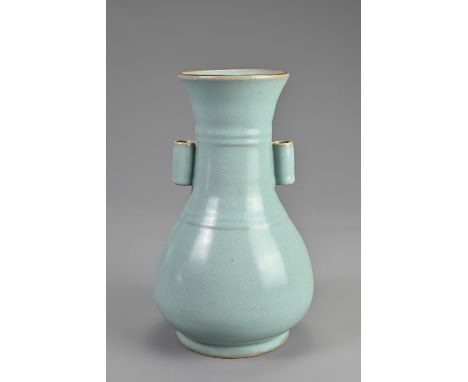 A CHINESE PORCELAIN ARROW VASE. Of pear shaped form with wide mouth and twin tubular handles, covered in a greyish blue glaze