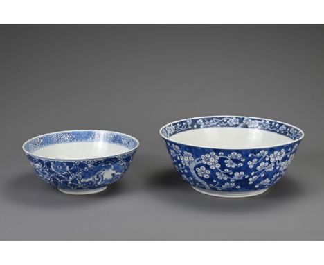 TWO CHINESE BLUE AND WHITE PORCELAIN BOWLS, 19TH CENTURY. To include a large punch bowl decorated with prunus blossoms with f