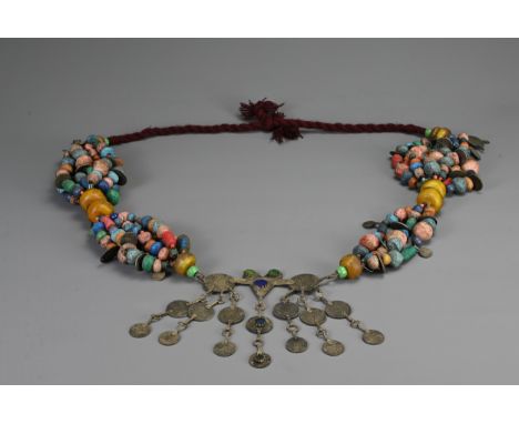 A LARGE MOROCCAN BERBER NECKLACE, 20TH CENTURY. Strung with various coloured ceramic and glass beads with coin drops and pend