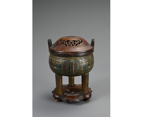 A CHINESE BRONZE ENAMEL CHAMPLEVE TRIPOD CENSER, 19/20TH CENTURY. Circular body with three flanges and two raised handles wit