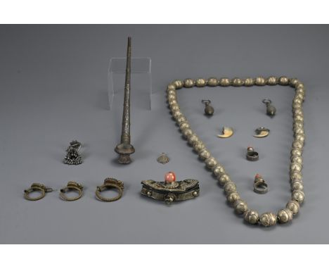 A GROUP OF TURKMAN, TIBETAN, HILL TRIBE ITEMS, 20TH CENTURY. To include an ethnic metalware beaded necklace; A pipe; A leathe