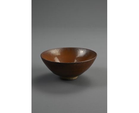 A CHINESE JIAN TYPE BROWN GLAZED POTTERY TEA BOWL. Rounded body covered in a brown glaze stopping short of the foot. 9.5cm di