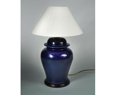 A modern blue-glazed pottery table lamp, of lidded ginger-jar form and with wooden stand and linen shade, unmarked but probab