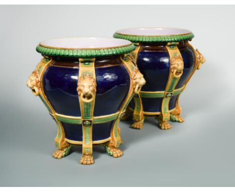 A pair of Minton majolica jardinieres, circa 1870, the blue ground baluster bodies with six divides moulded with lion mask an