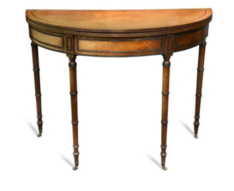 A Regency mahogany demi-lune tea table, with ebony line border inlay and ebonised outline mouldings, on ring turned column le