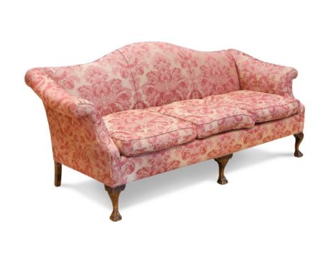 A George II style sofa, with a shaped back, upholstered in a woven damask fabric, on ball and claw cabriole legs 86 x 195 x 9