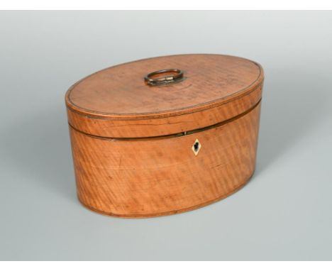A George III oval satinwood tea caddy, the hinged cover opening to reveal a twin compartment fitted interior 13 x 22.50cm (5 