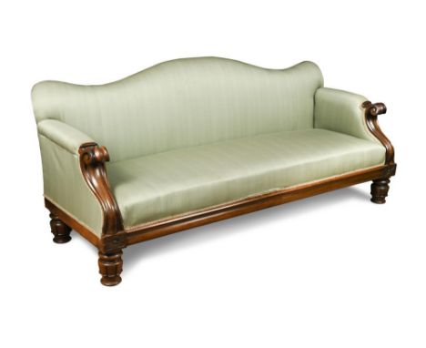A Large William IV rosewood framed sofa, with a serpentine outline back, scroll carved arm terminals, on gadroon moulded and 