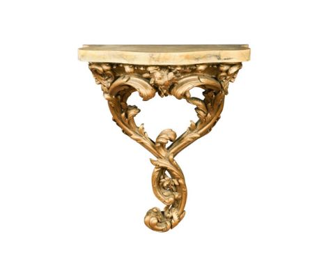 A 19th century carved giltwood serpentine console, the serpentine Sienna marble on a boldly carved acanthus leaf and foliate 