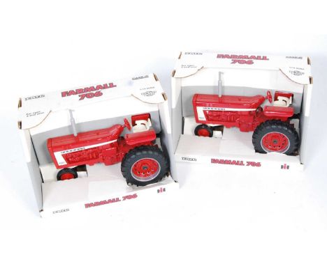 An Ertl 1:16 scale large diecast tractor group, comprising 2x Farmall 706 tractors, both housed in the original open front al