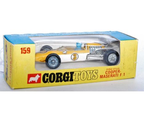 A Corgi Toys No. 159 Cooper Maserati F1 race car comprising of yellow and white body with blue driver figure and racing No. 3