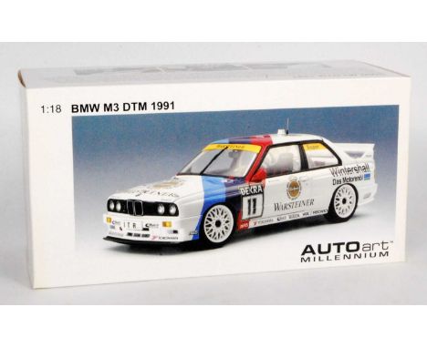 An Auto Art Millennium model No. 89146 1/18 scale model of a BMW E30 M3DTM 1991 race car finished in Warsteiner livery, with 