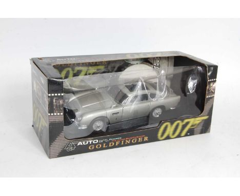 An Auto Art 1/18 scale model of a James Bond Goldfinger Aston Martin DB5 in the original window box, box outer slightly torn 