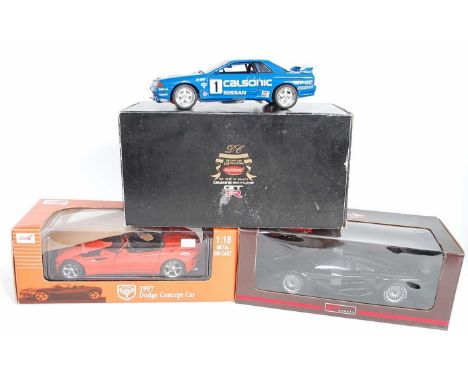 A 1/18 scale boxed diecast group to include a Kyosho 1/18 scale model of a Calsonic Skyline GTR, together with an Anson 1/18 