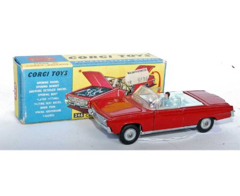 A Corgi Toys No. 246 Chrysler Imperial Saloon, comprising of red body with light blue interior and two figures, with cast hub