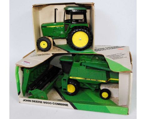 An Ertl John Deere combine and tractor large scale heavy metal group, to include a John Deere utility tractor, and a John Dee