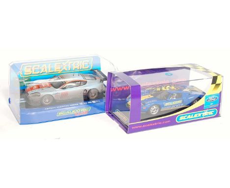 A boxed as issued Scalextric slot car racing group, two examples to include Ref. No. C2965 No. 009 Aston Martin DBR9, a Scale