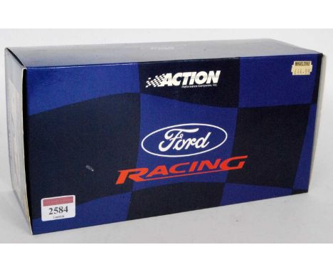 An Action Performance Racing 1/18 scale model of a Ford Focus WRC2000 race car finished in red, blue and white with Martini l