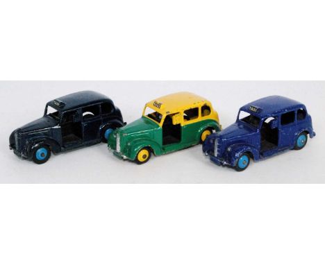 Three various loose Dinky Toy taxis to include Austin Taxi finished in green and yellow, a No. 40H Austin taxi finished in da