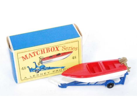 A Matchbox 1:75 series No.48 trailer with removable sports boat, comprising of dark blue trailer with white and red boat, wit