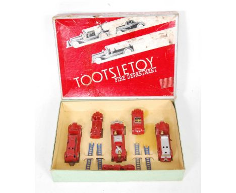 A Tootsie Toys No.411 Fire Department gift set, appears complete, comprising of 5 various vehicles with four blue ladders, so