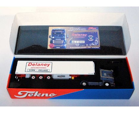 A Tekno 1/50 scale model of a Delaney International Scania R500 V8 tractor unit with refrigerated trailer, housed in the orig