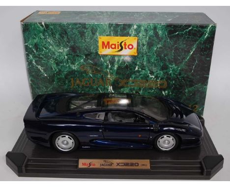A Maisto 1/12 scale model of Jaguar XJ220 1992 race car finished in metallic dark blue, housed in the original polystyrene pa