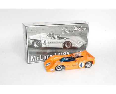 A GMP No. 12021 1/18 scale model of a Bruce Maclaren M8A race car comprising of orange body with racing No. 4, housed in the 