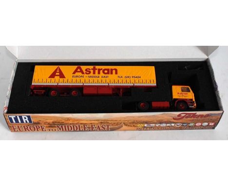 A Tekno 1/50 scale boxed model of a Scania 142M tractor unit and classic tilt trailer finished in Astran Europe to Middle Eas