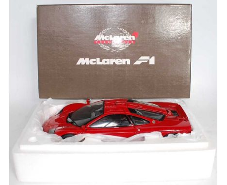 A Minichamps Maclaren Collection model No. 530133125 1/12 scale model of a Maclaren F1 road car finished in red, appears as i