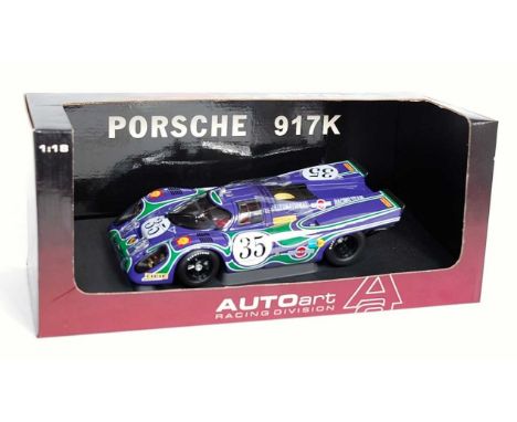 An Auto Art Racing Division 1/18 scale model of a Porsche 917K Watkins Racing Team race car comprising purple and green body 