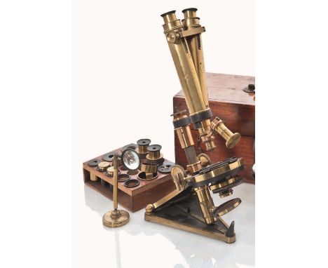 A BINOCULAR TRUNK-TYPE MICROSCOPE BY R. & J. BECK, LONDON, CIRCA 1900
with lacquered and oxidised brass bedplate with hinged 