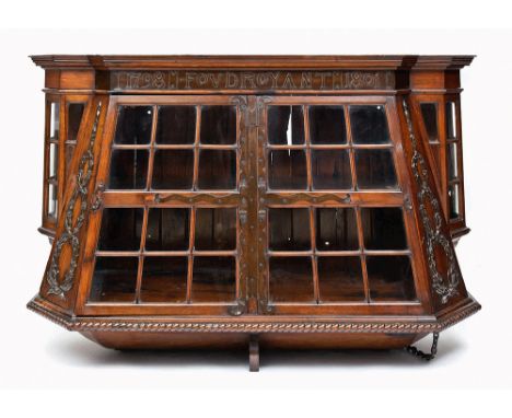 A RARE BOOKCASE/DISPLAY CABINET MADE FROM FOUDROYANT OAK AND COPPER BY GOODALL, LAMB & HEIGHWAY, CIRCA 1899
modelled as a shi