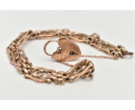 A YELLOW METAL FANCY GATE BRACELET, designed with a series of openwork links interspaced with oval links, unmarked, fitted wi