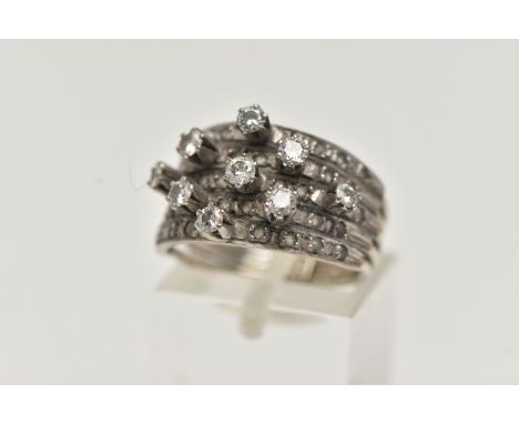 A WHITE METAL DIAMOND RING, comprising of five individual bands fitted together with a band stamped 18k, ring shanks are unma