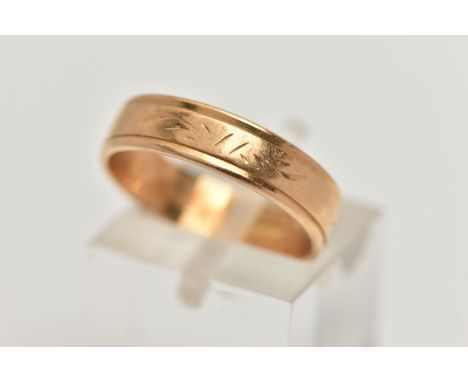 A POLISHED WIDE BAND RING, worn engraved detail to the band, approximate band width 4.8mm, stamped 750, ring size centre M, a