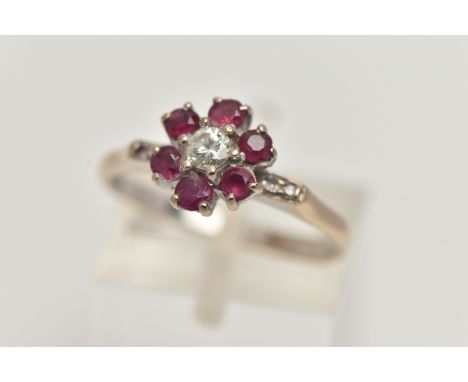 A YELLOW METAL, DIAMOND AND RUBY CLUSTER RING, flower cluster set with a central round brilliant cut diamond, estimated diamo