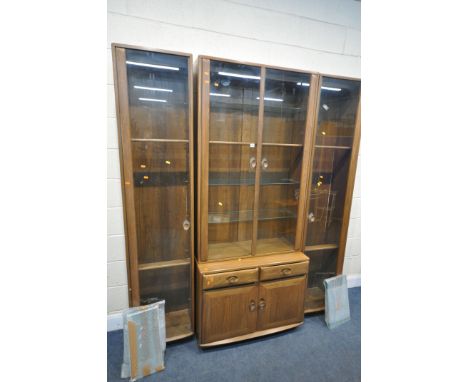 AN ERCOL WIDSOR ELM DISPLAY CABINET, with an arrangement of four sections, width 188cm x depth 47cm x height 214cm (condition